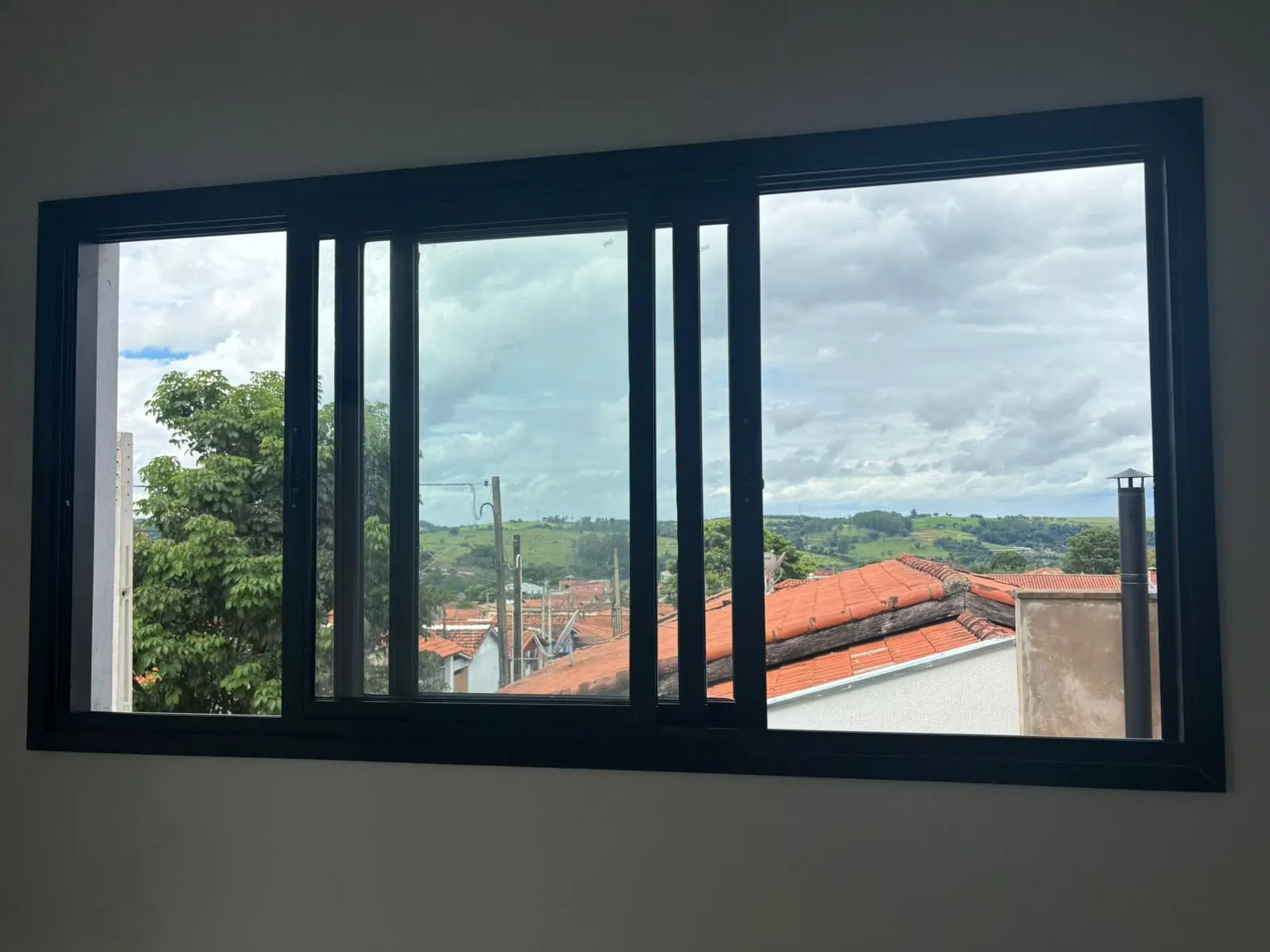 Janela de correr em alumínio preto com vista para as montanhas