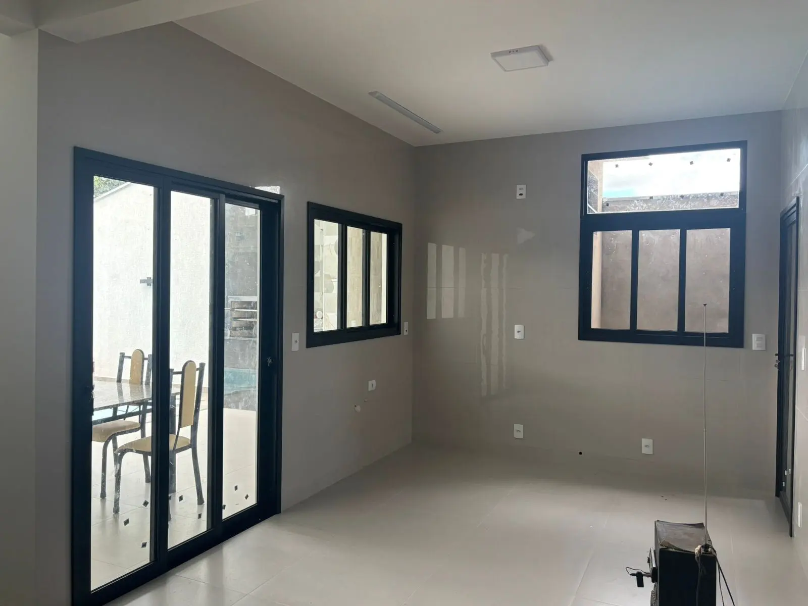 Porta de correr em alumínio preto com vidro instalada pela BomBox Vidraçaria